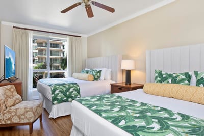 Tropical-inspired double room with balcony view and cozy seating area.