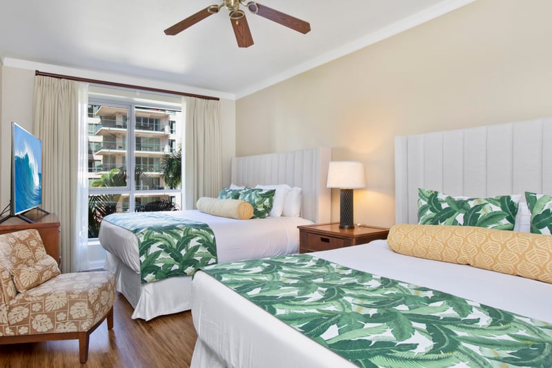 Tropical-inspired double room with balcony view and cozy seating area.