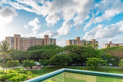 Scenic balcony view overlooking lush greenery and resort high-rise towers