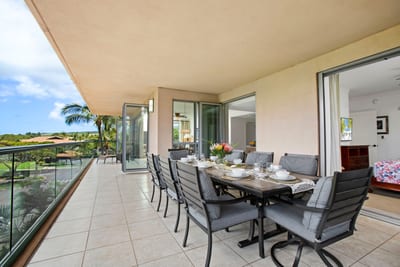Elegant outdoor dining on a tropical lanai with scenic views