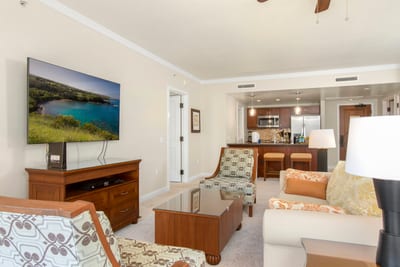 Spacious island suite with modern kitchen, cozy seating, and entertainment.
