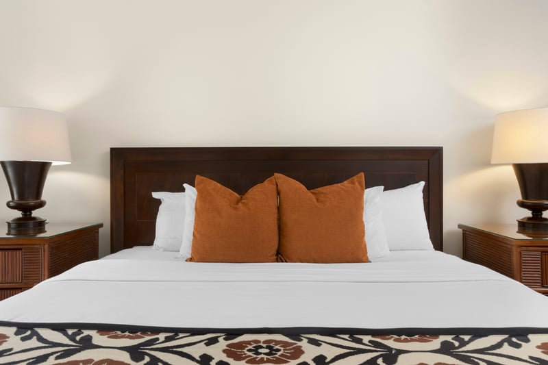 Cozy island bedroom with warm tones, soft linens, and comfort.