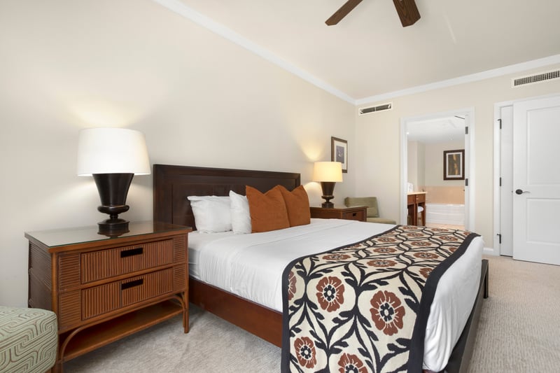 Tropical bedroom retreat with elegant decor, plush bed, and ensuite.