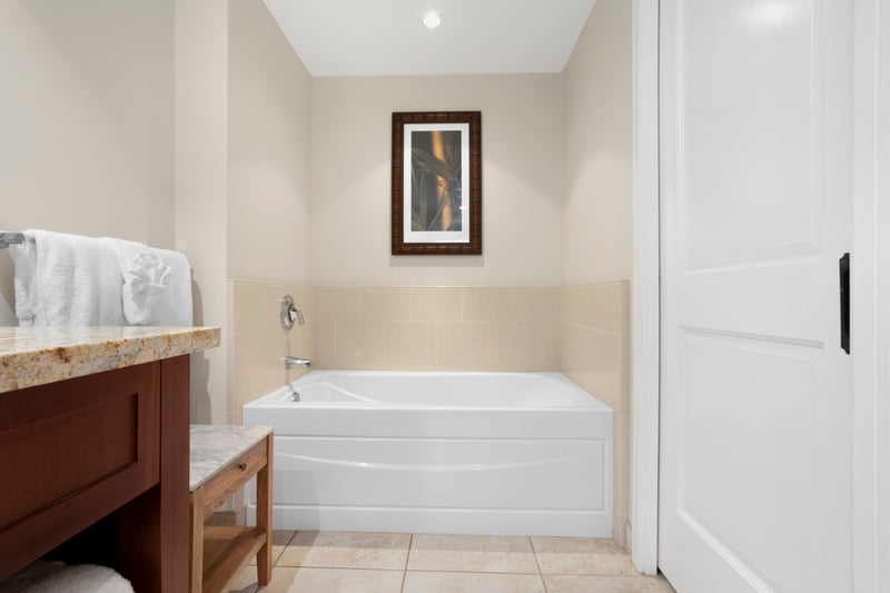 Relaxing spa-style soaking tub with warm tones and tropical elegance.