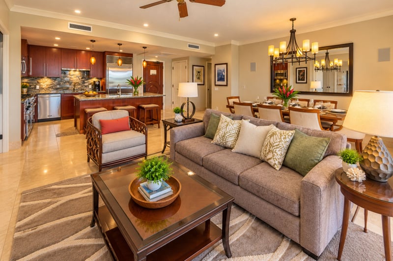 A comfortable sofa and accent chair in the open living area flow into the dining space and kitchen, ideal for relaxing together after a beach day.