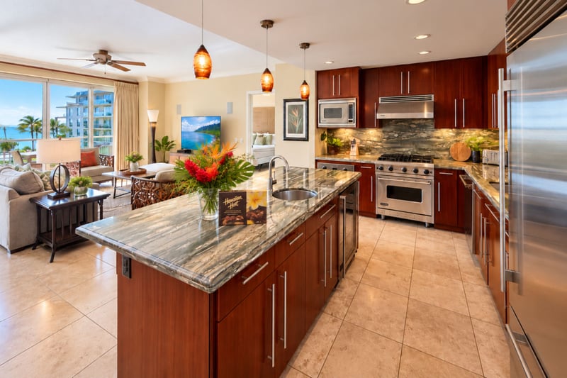 Stainless steel appliances, an island with a sink and wood cabinetry make the kitchen easy to cook in while staying part of the conversation.
