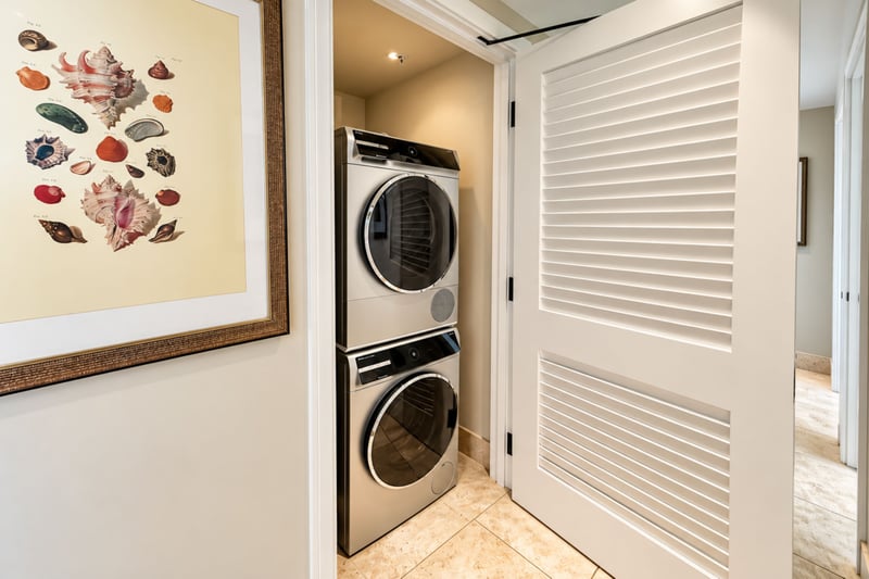 A stacked washer and dryer tucked behind louvered doors keep laundry convenient during longer stays.