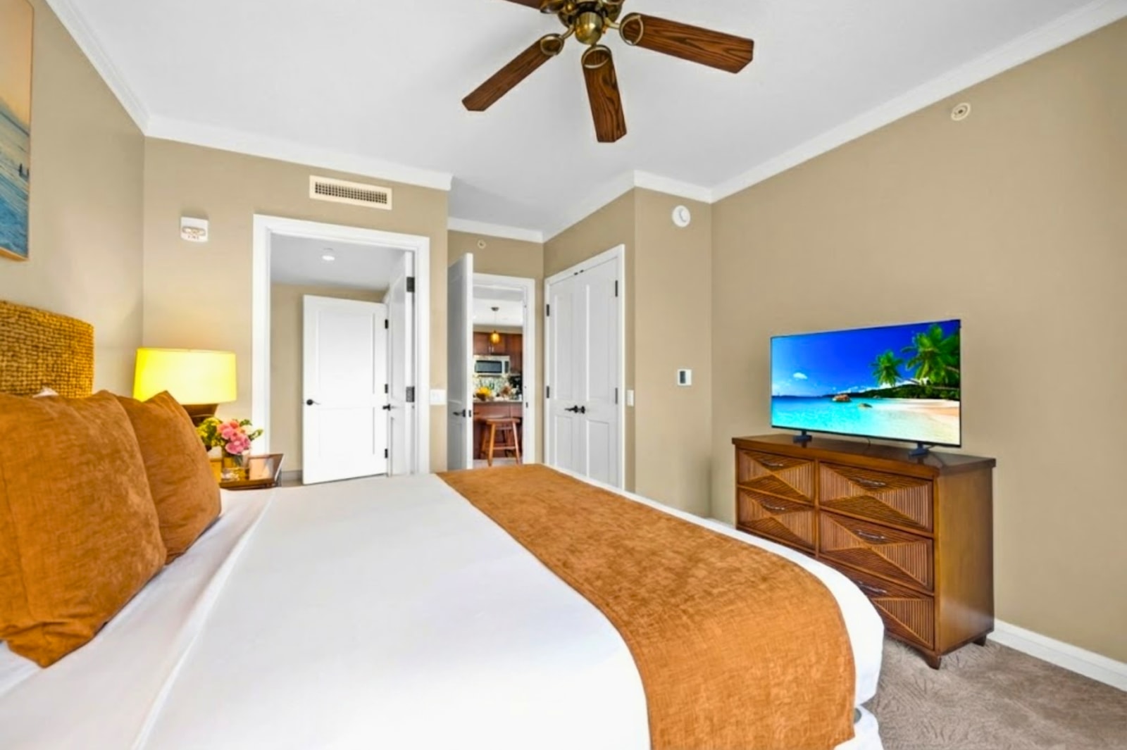 The spacious primary bedroom features a comfortable king size bed and tasteful island decor HKK-434