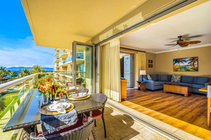 Open your living room to the balcony for seamless indoor-outdoor dining with pool and garden views.