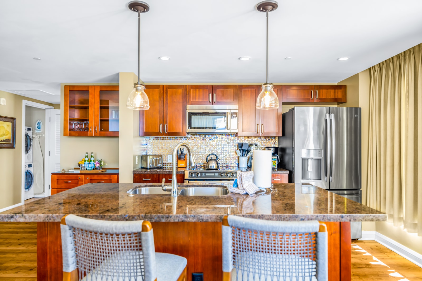 Bar seating and pendant lighting give this kitchen a welcoming, social vibe for drinks or breakfast on the go. HKK-439