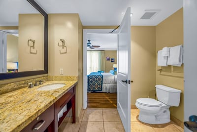Tiled floors and a wide vanity make this guest bathroom both functional and welcoming.