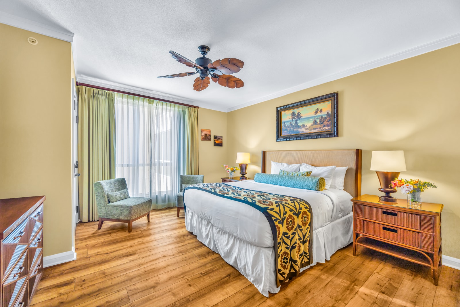 The second bedroom includes a Queen bed, balcony access, and soft natural light for a peaceful stay. HKK-439