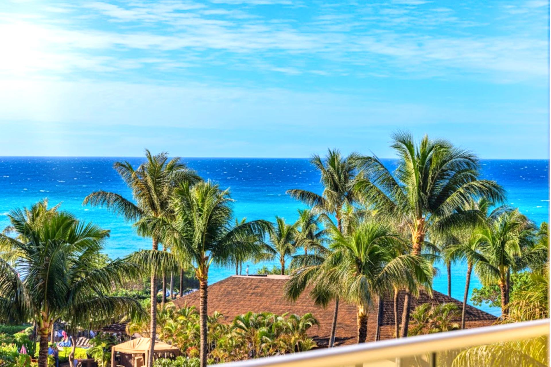 Palm-lined ocean views await from your spacious lanai, perfect for a quiet morning or golden hour unwinding HKK-443