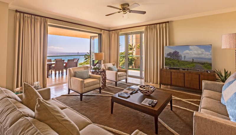 Cozy, open living space with tropical tones, plush seating, and direct access to a breezy lanai.