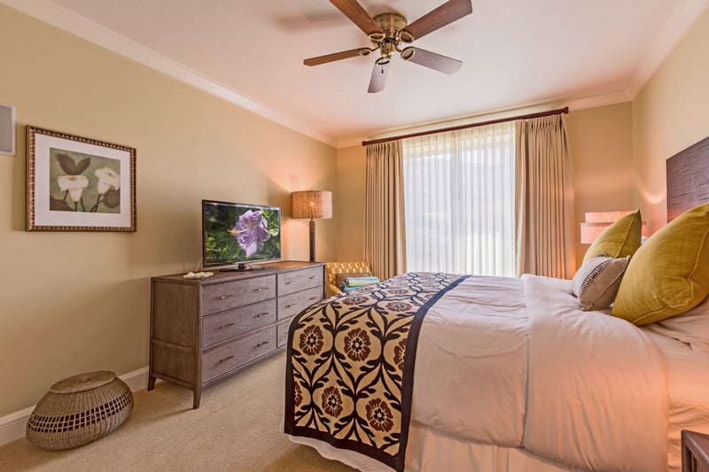 A peaceful guest room with warm tones and natural light