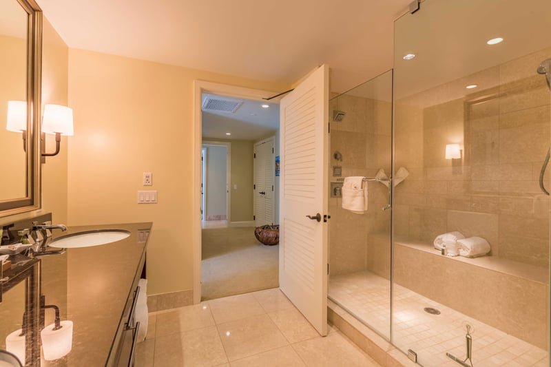 Glass shower and rich tile give this bathroom a touch of luxury