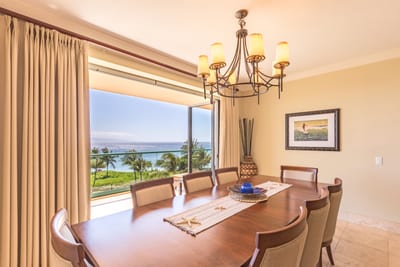 Elegant dining room with ocean-view windows, perfect for sunset dinners and special meals.