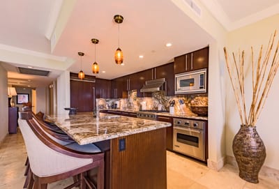 Stylish kitchen with granite counters and pendant lighting, designed for both chefs and casual grazers.