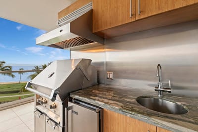 Grill in paradise—this sleek ocean view outdoor kitchen features premium stainless steel appliances, granite countertops, and island-style luxury HKK-451