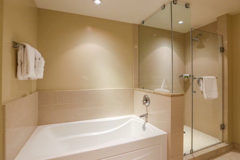 Modern bathroom retreat with glass shower and deep soaking tub. HKK-513