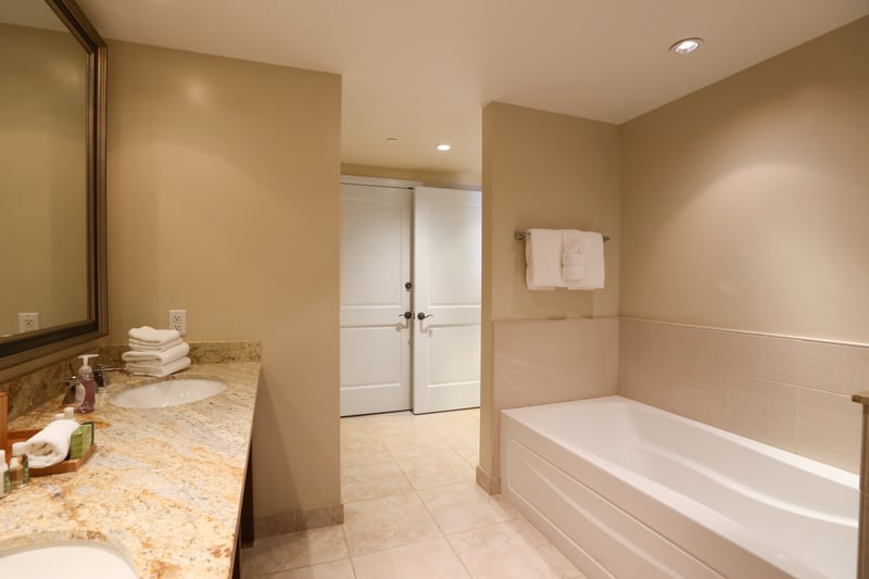 Inviting bathroom with soaking tub, double sinks, and soft lighting