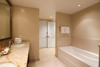 Inviting bathroom with soaking tub, double sinks, and soft lighting