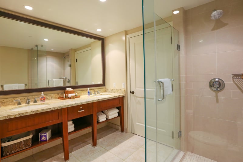 Spacious bathroom with double vanity, glass shower, and elegant finishes.