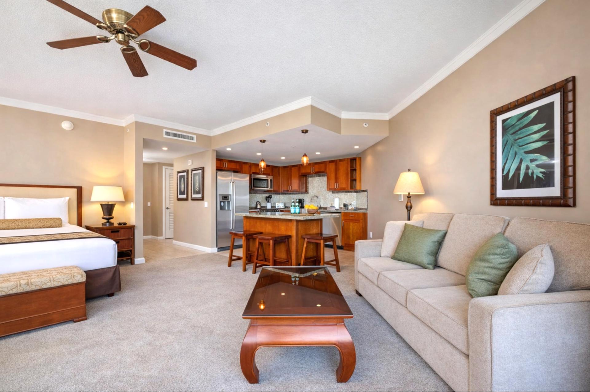 Your open studio welcomes you with a plush bed, sofa seating, and a full kitchen just steps away, creating an easy space for both rest and island living.