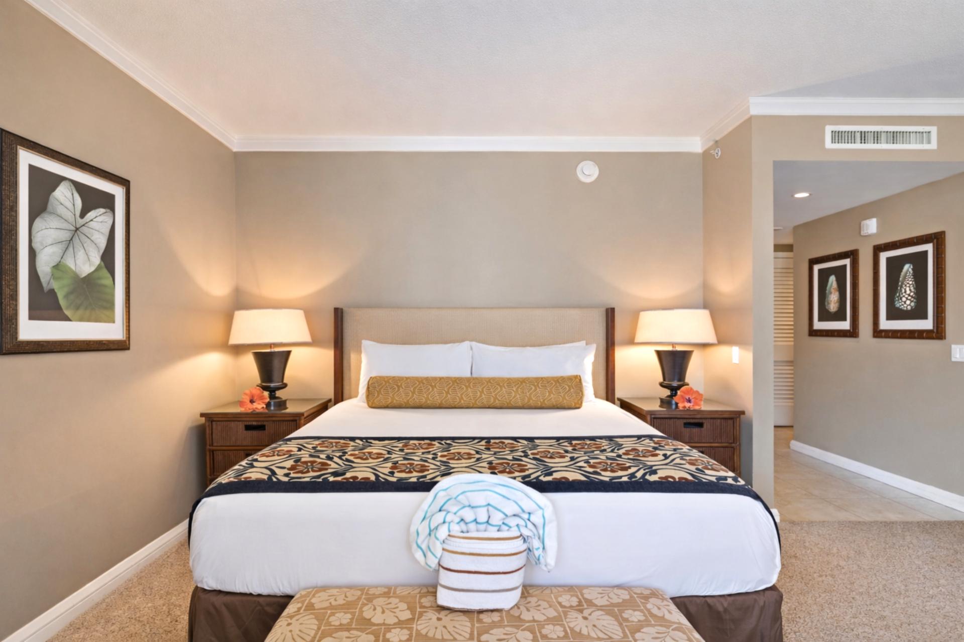 Your sleeping area features crisp bedding, warm island decor, and soft lighting that makes settling in after a beach day feel effortless.