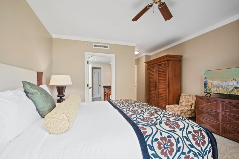 Cozy island bedroom with plush bedding, tropical charm, and tranquility.