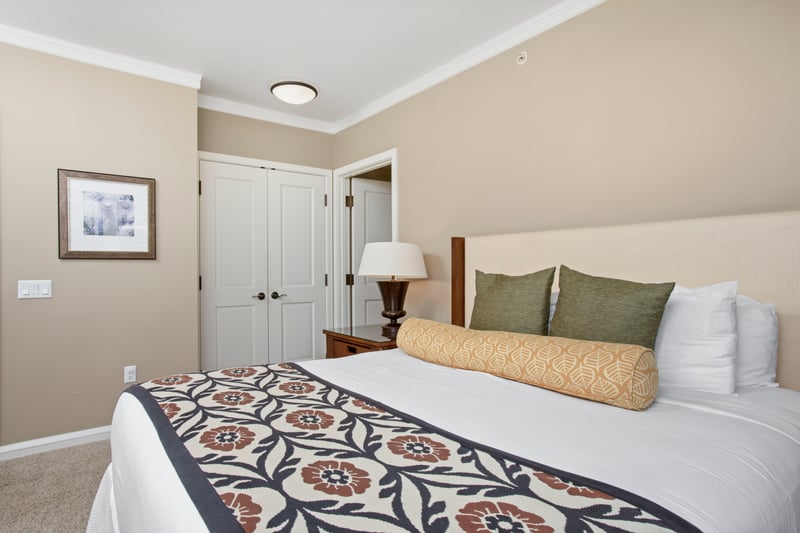 Peaceful bedroom retreat with plush pillows, floral bedding, and calm tones.