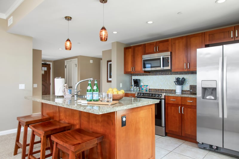 Stylish gourmet kitchen with island seating, stainless steel, and elegance.