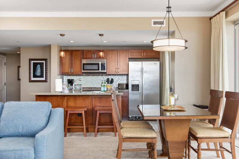 Modern island kitchen with dining, wine, and sunshine-ready relaxation space.