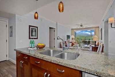 Modern island kitchen meets scenic luxury with mountain view dining.