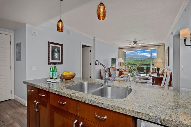 Modern island kitchen meets scenic luxury with mountain view dining.