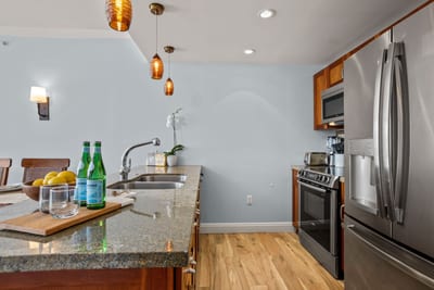 Modern island kitchen with stainless steel finishes and inviting ambiance.