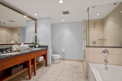 Spacious bathroom with double vanity and upgraded shower