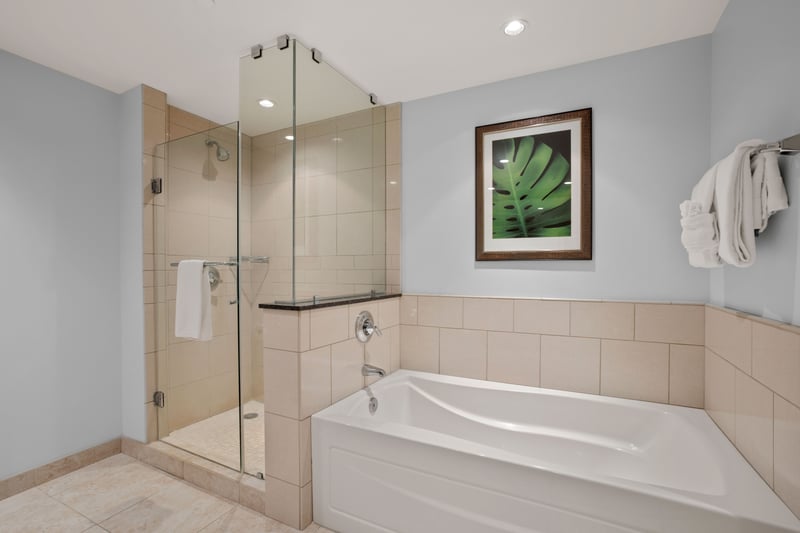 Elegant bathroom with soaking tub, glass shower, and plenty of space