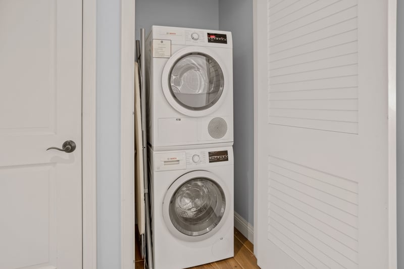 Convenient in-unit laundry with stacked Bosch washer and dryer appliances.