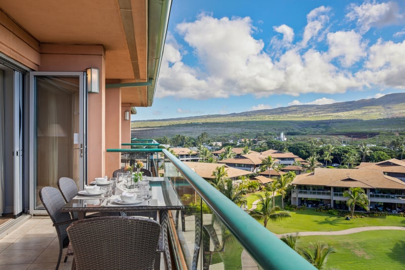 Scenic balcony dining with mountain views and tropical resort surroundings.