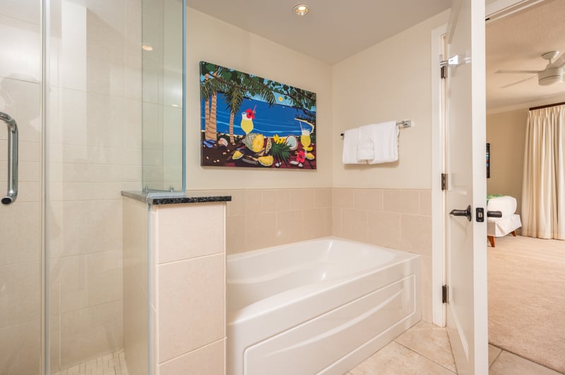 Elegant bathroom retreat with tropical art and seamless bedroom access.