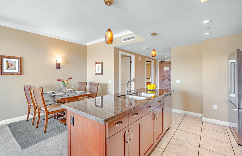 Modern island kitchen with granite counters, perfect for elegant dining moments. HKK-820