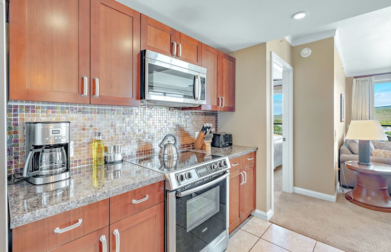 Stylish kitchen with mosaic backsplash, modern appliances, and cozy layout. HKK-820