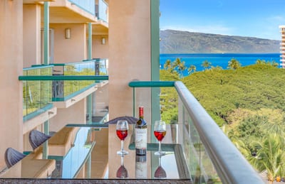 Wine reflections, island breeze, ocean view framed by luxury living.