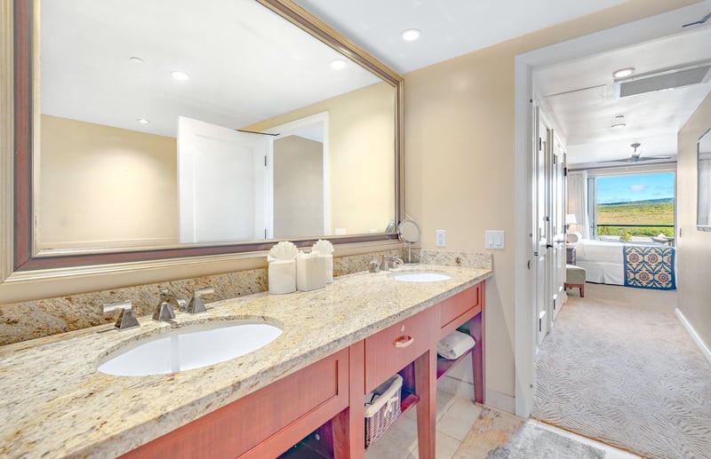 Elegant dual-sink vanity with granite charm and scenic suite views. HKK-820