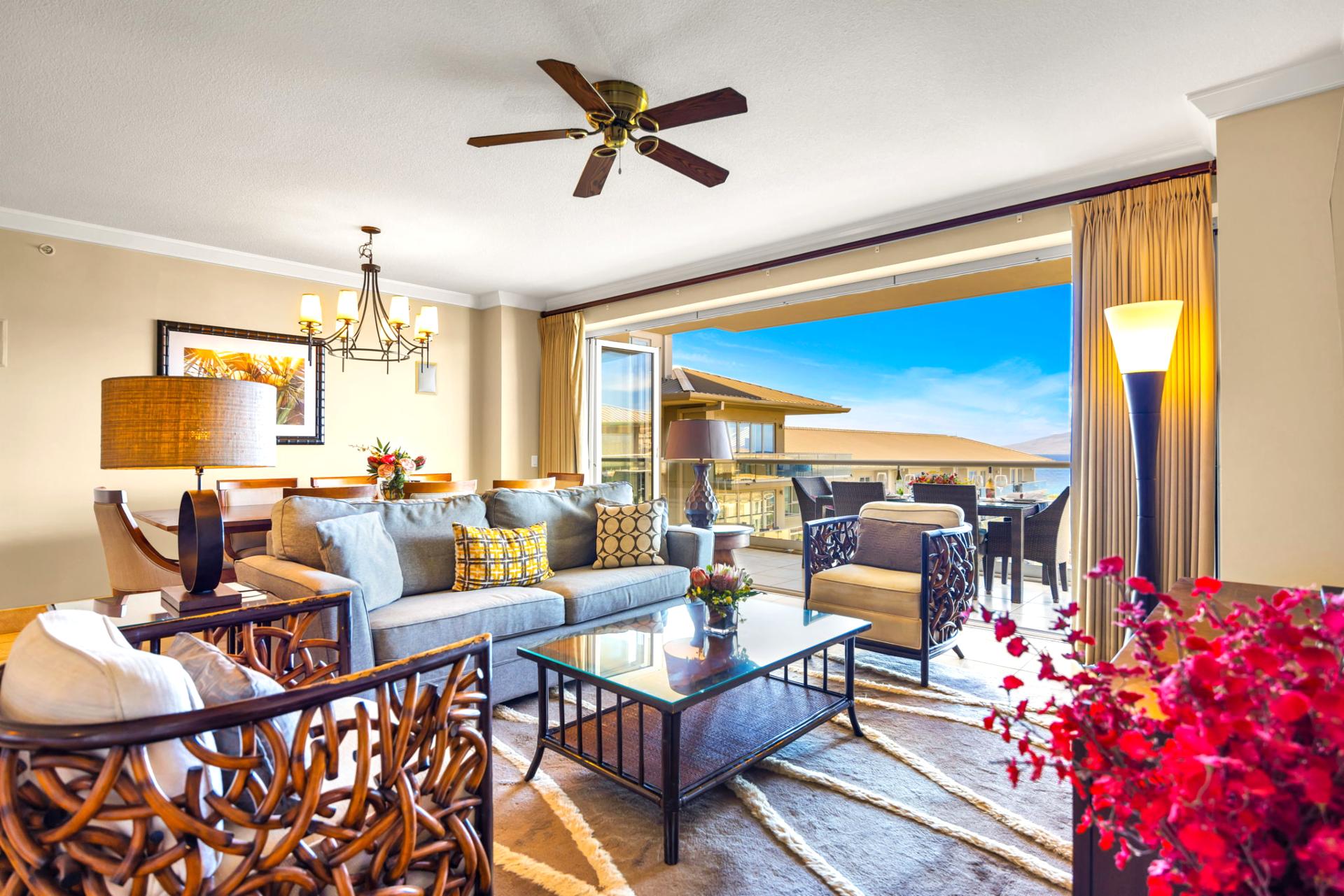 Bright and airy living space with plush seating and tropical views.