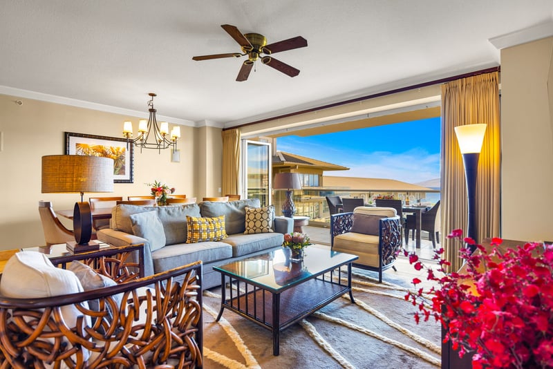 Bright and airy living space with plush seating and tropical views.