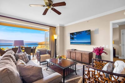 Comfortable living area with sectional sofa, Smart TV, and island views through wide sliding doors. HKK-825