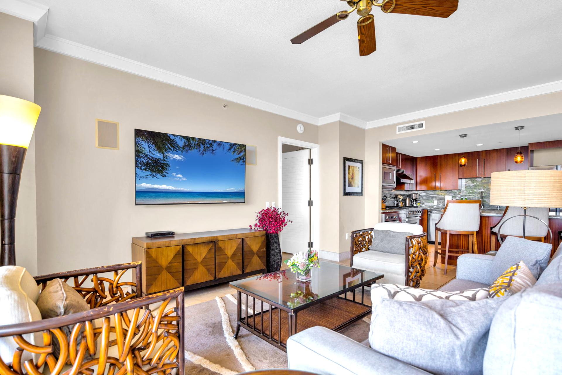 Living room blends comfort and space with direct access to the lanai and open dining nearby.