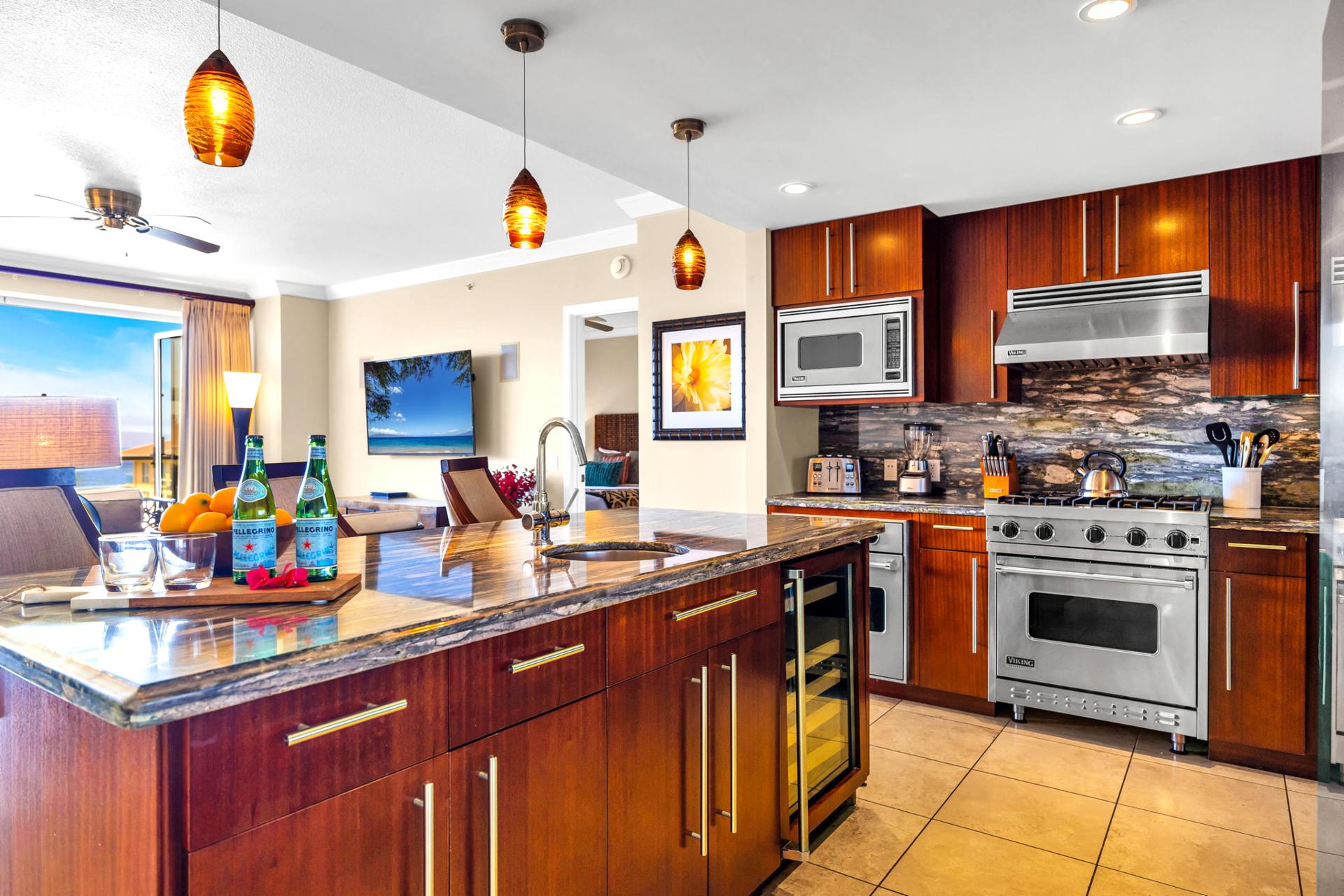 Full kitchen with granite counters, stainless appliances, and bar seating for casual dining.